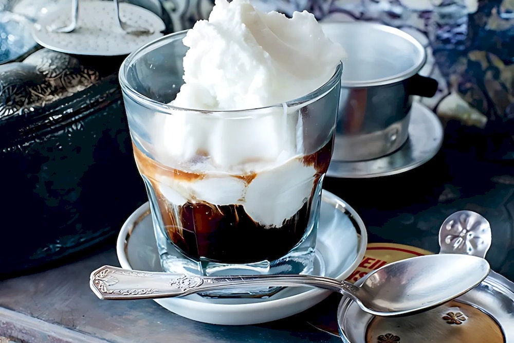 Coconut coffee in Vietnam blends robusta espresso with creamy coconut milk and crushed ice for a smooth, tropical taste